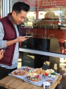 Man taking a picture of Fresh mediterranean food